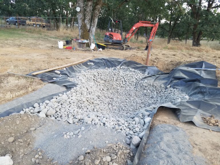 Nearly every cobble in the pond area was placed by hand to obtain an even layer as well as to avoid damage to the liner.