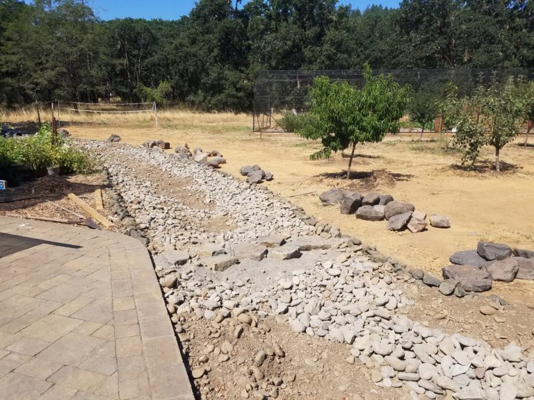On top of the "bar run" was placed more cobble to serve as the streamside substrate. Boulders were staged streamside for next step of creating more stream channel structure.
